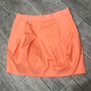 Bright orange mini skirt.